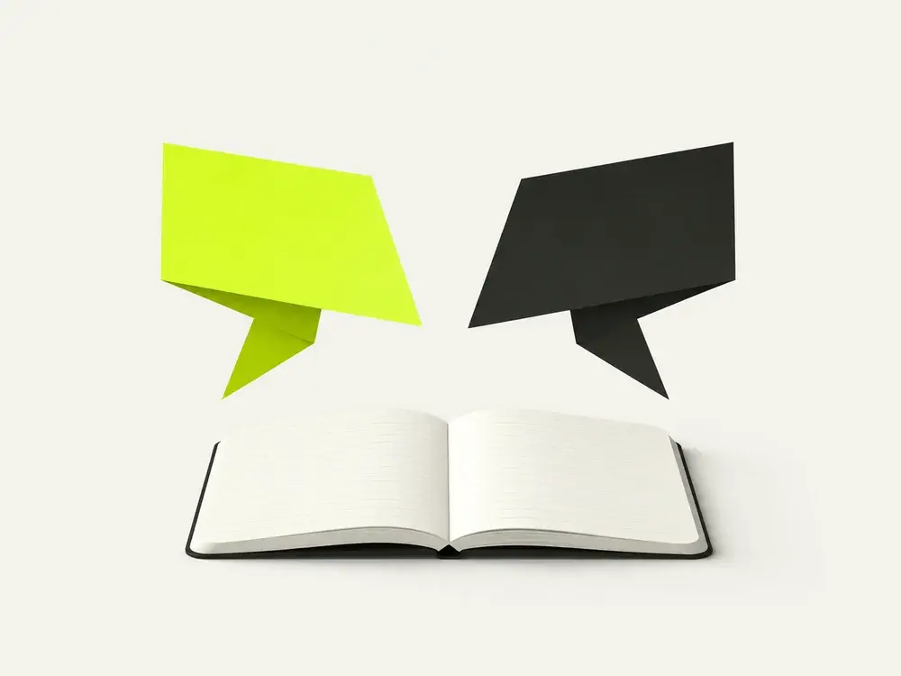 An open notebook between two conversation shapes